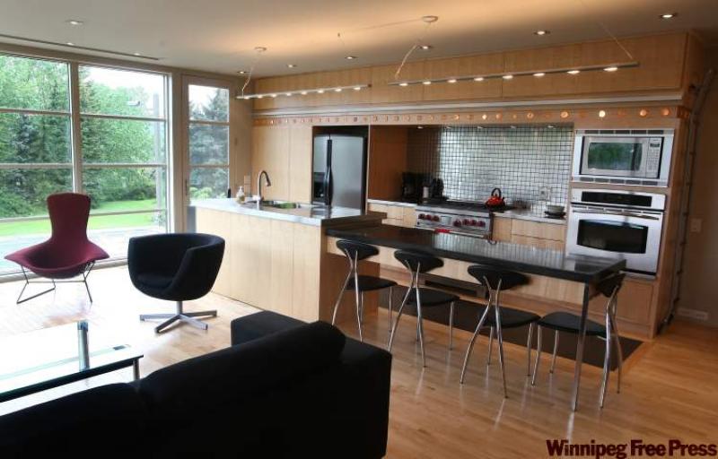 CORK INLAY: Cork is inlaid into this open kitchen, providing soft cushioning.