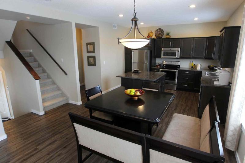 The kitchen and eating areas are a shared space, providing a bright, open feel. 