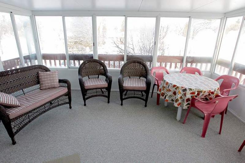 A three-season sunroom that faces west is great for entertaining.