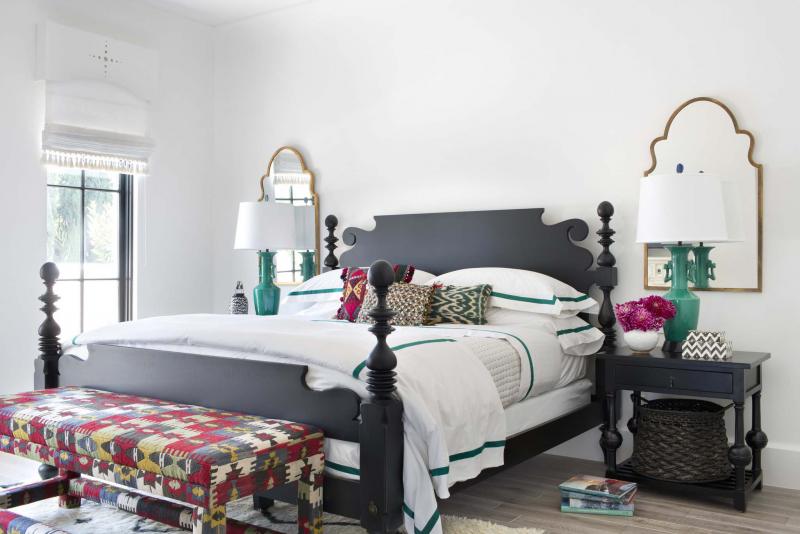 <p>Sarah Dorio / Betsy Burnham via AP</p><p>Layered linens, plush upholstery and soft throw pillows infuse a feeling of welcoming luxury into this guest bedroom. </p>