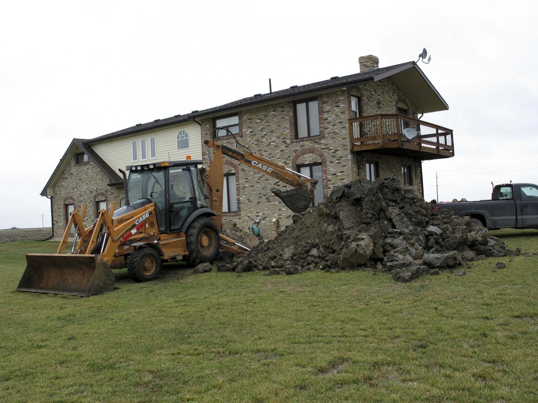 <p>Marc LaBossiere / Winnipeg Free Press</p><p>A backhoe digs around the old concrete septic tank, which was located directly beneath where a new deck was to be built. </p>