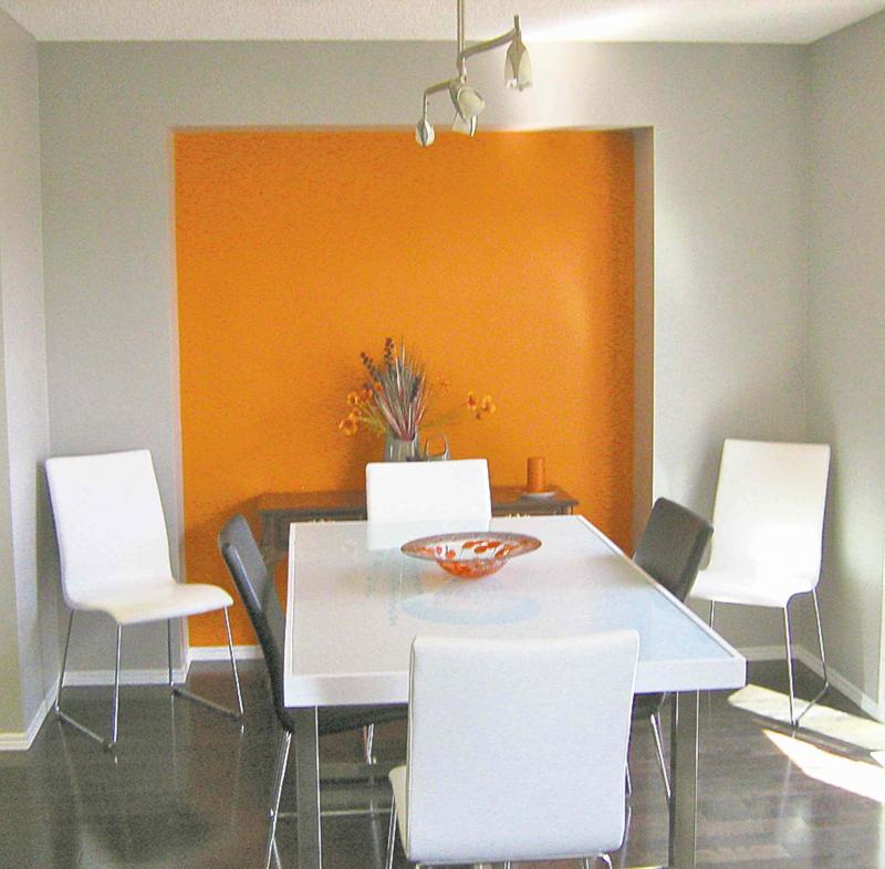 The dining room niche looks great with dark flooring and white suite.