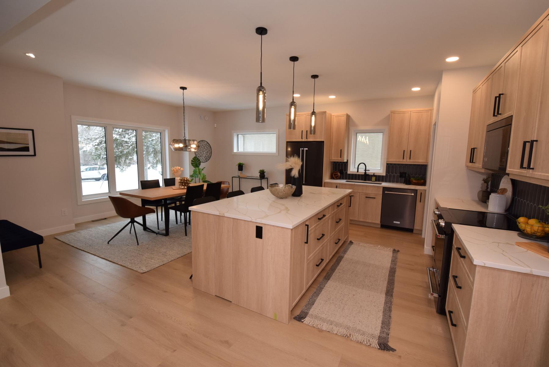  <p>photos by Todd Lewys / Free Press</p>
                                <p>The gorgeous island kitchen opens beautifully onto a spacious, naturally bright dining area that can seat anywhere from six to 10 guests.</p> 