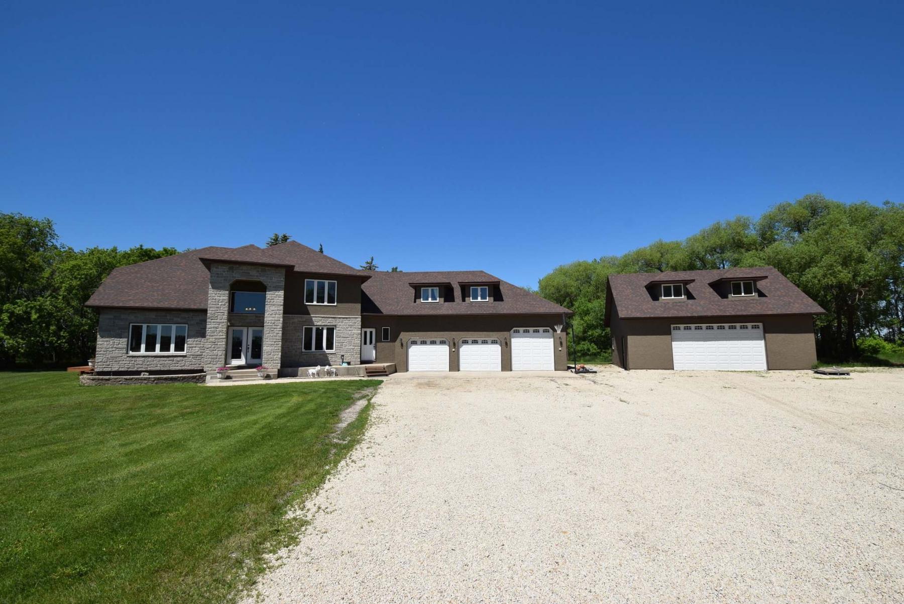 <p>Situated on a gorgeous 11.2-acre lot, the impeccably built two-storey masterpiece offers 3,995 square-feet, plus a detached double garage with a loft area above.</p>