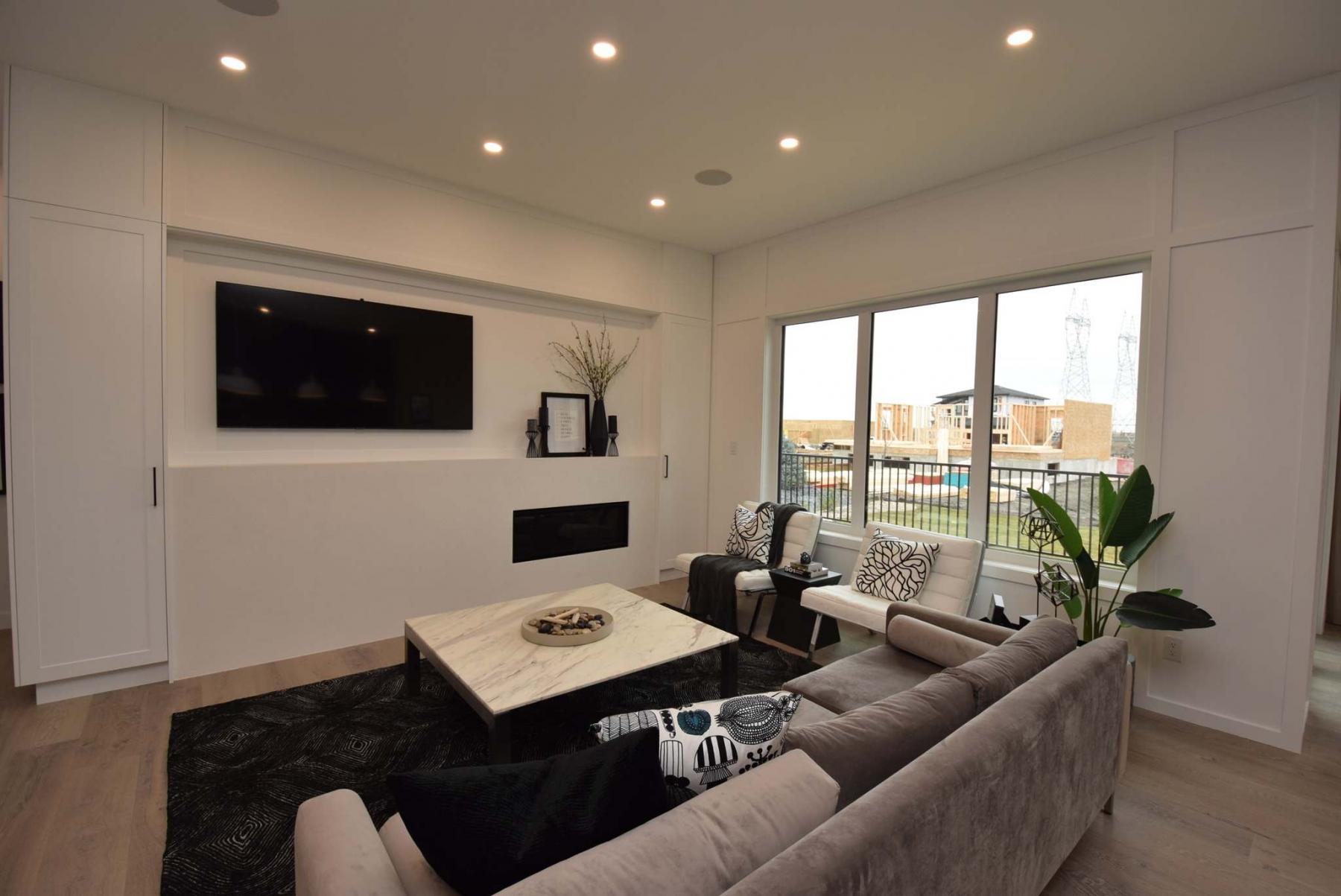 <p>Photos by Todd Lewys / Winnipeg Free Press</p><p>A white entertainment unit with oversized TV niche and linear fireplace serves as the spacious family room&rsquo;s focal point.</p></p>