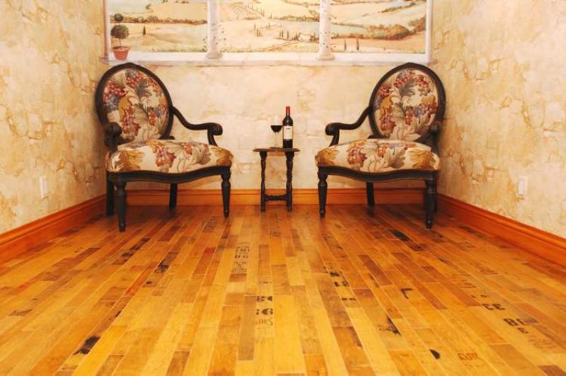 Wine barrel flooring: They start by breaking apart the barrel and removing the metal hoops, separating the heads and pulling apart the staves. They then engineer it into flooring.