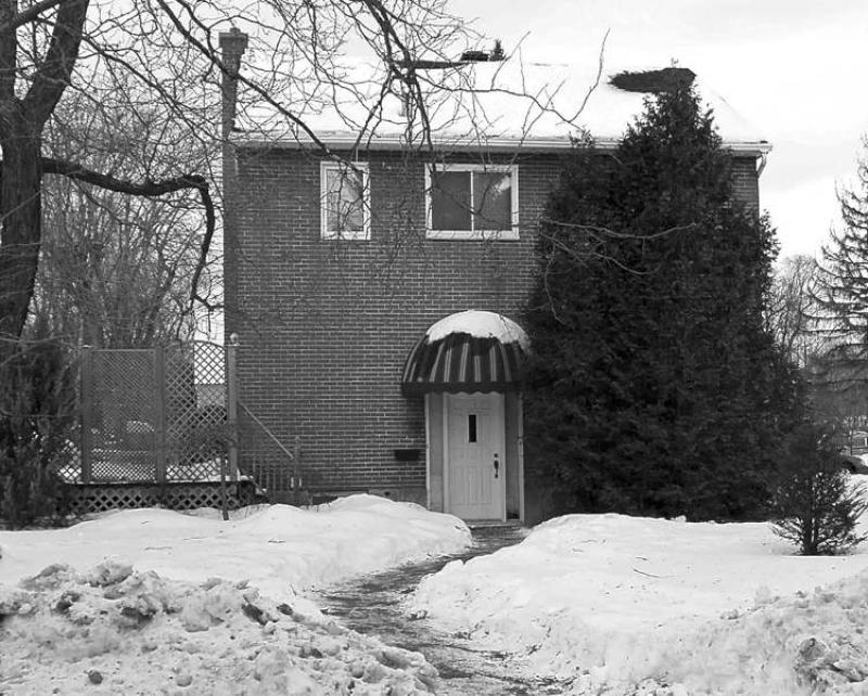 A small cedar that was planted to fill in the imposing, empty brick space on the right side of the home has become huge and now blocks the passageway to the driveway. (Courtesy)