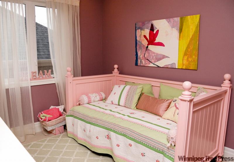 A daybed is a versatile choice for a young lady's bedroom, doubling as a place to  play and sleep.