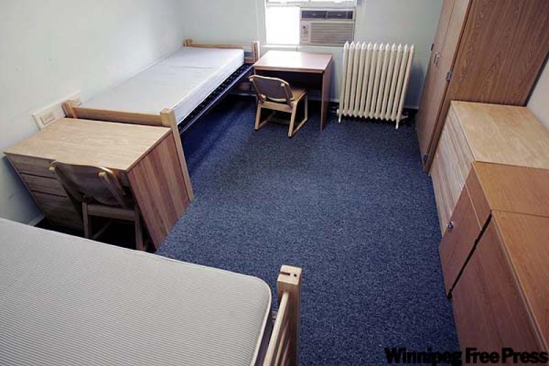 Raising beds to gain storage space and reduce clutter is key to decorating a dorm room, designer Anna Riopelle says. (Canwest News Service photo)
