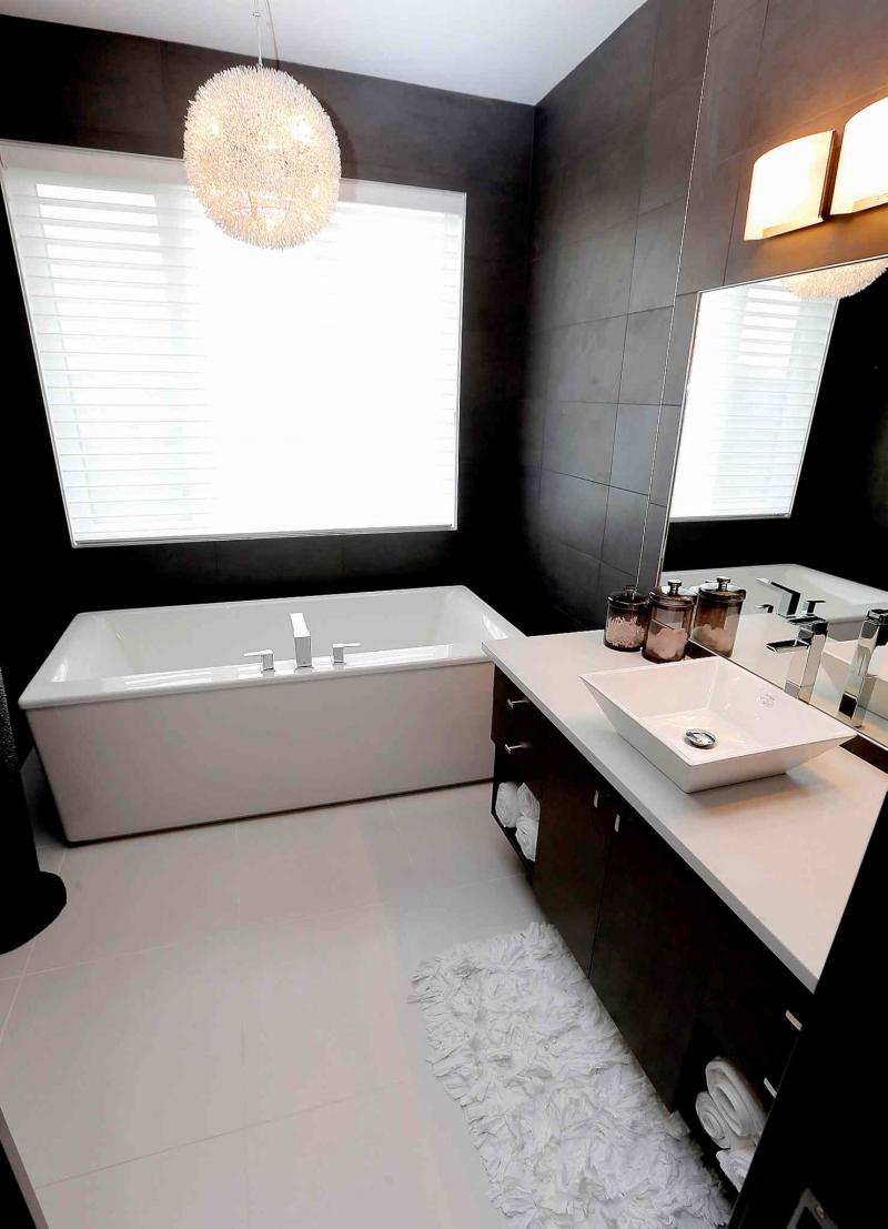 A spa-like ensuite features a 6-foot, stand-alone soaker tub and a 5-foot tempered glass shower.