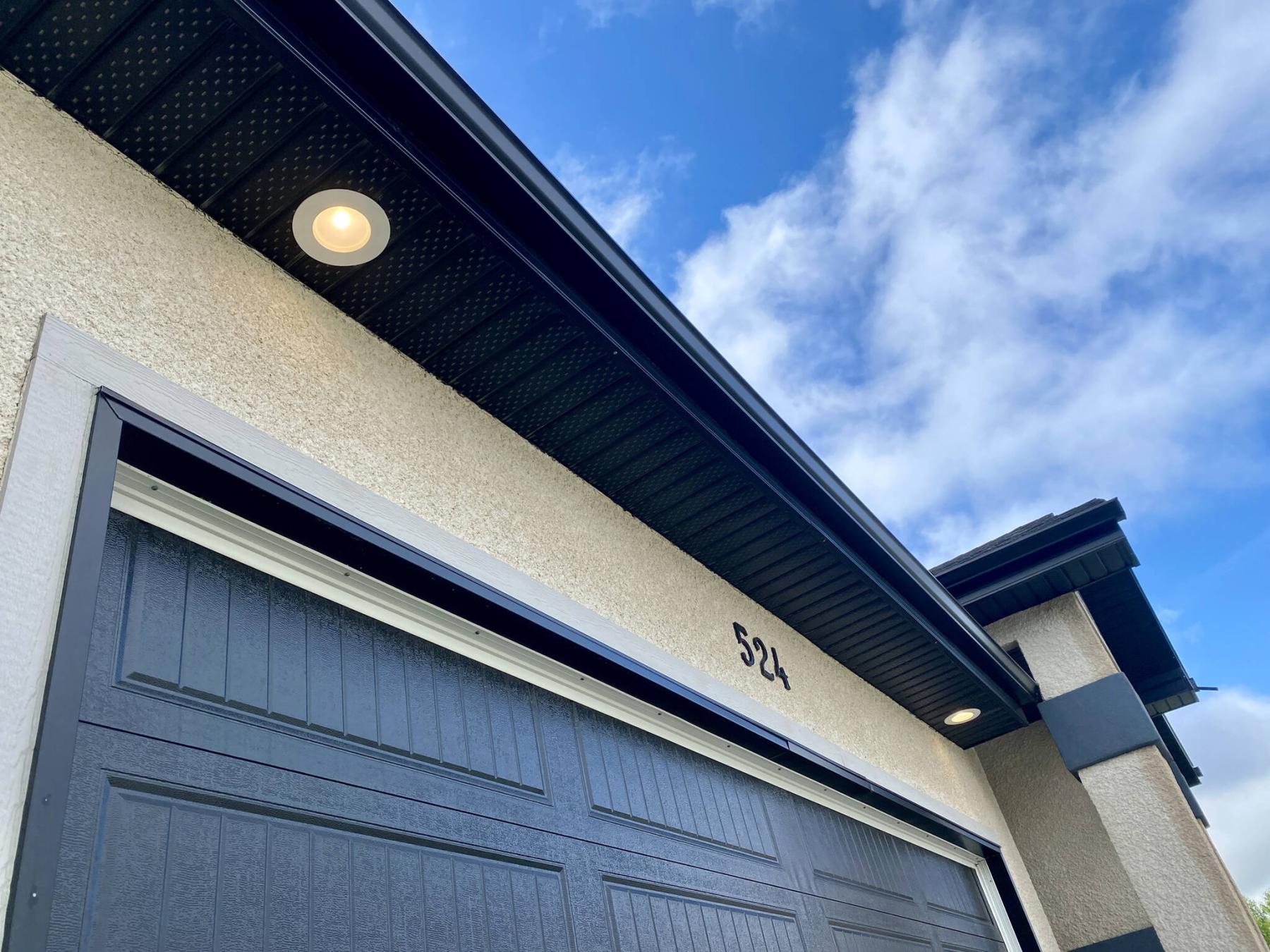  <p>Photos by Marc LaBossiere / Free Press</p>
                                <p>The two lighting locations along the dark brown soffit of the garage at the front of the house were upgraded to retrofit LEDs.</p> 