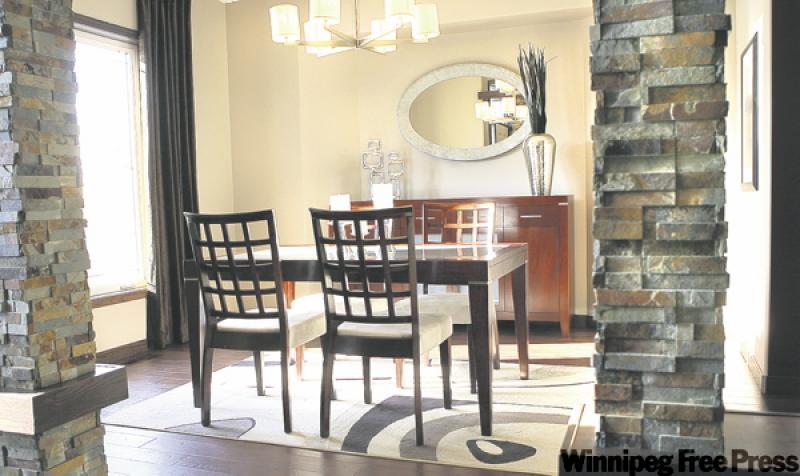 A wide foyer flows naturally into a large dining room defined smartly by multicoloured slate pillars with oak accents.