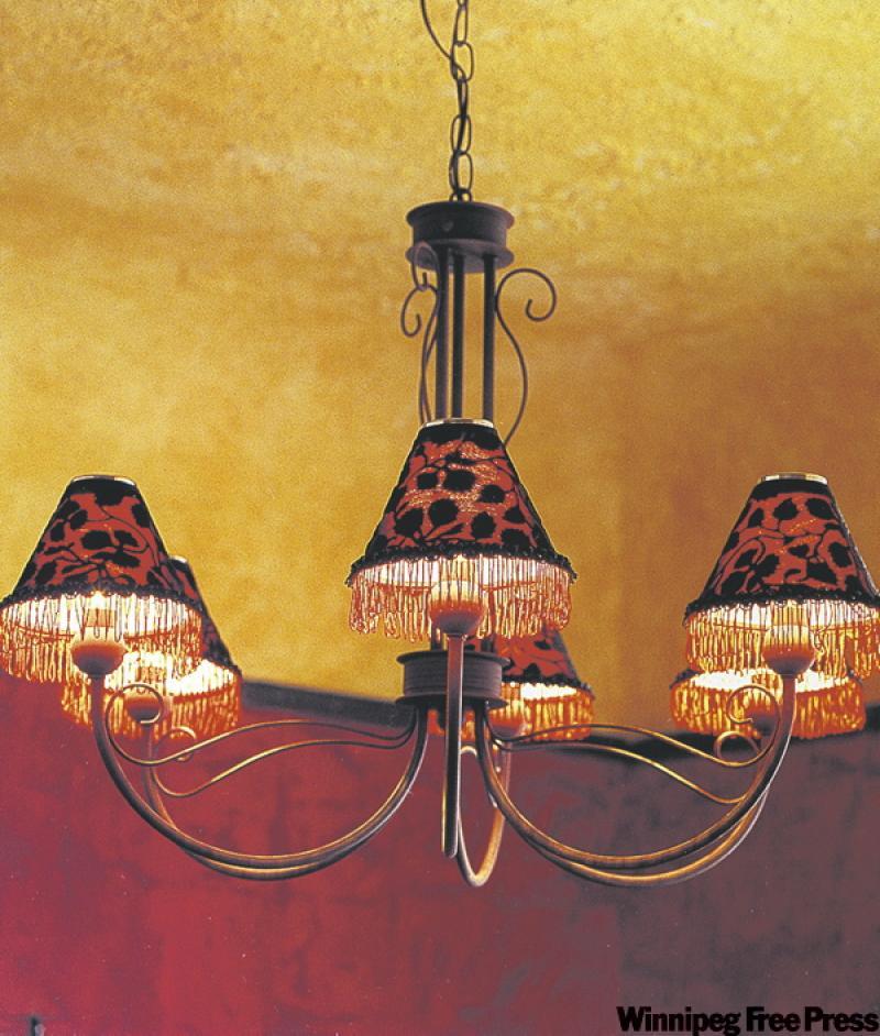 Dramatic shades for the wrought iron chandelier were made using sexy sheer fabric and lush trim.