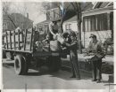 Winnipeg Free Press Archives
Winnipeg WWII Home Front
April 23, 1942
Boulevards Yielding Treasures in Salvage Cartons, bags, boxes and containers piled in front of your next door neighbor's house no longer means that they are moving cut. It mear.s that the Patriotic Salvage Corps' new boulevard pick-up system is in full swing. Salvage collectors and their trucks were snapped by the Free Press cameraman, Thursday morning, while working; on Arlington street.