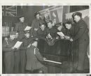Winnipeg Free Press Archives
Winnipeg WWII Home Front
April 6, 1940
All happy and gay Soldiers stationed in the Winnipeg district will not lack recreation. Here is the Knights of Columbus army hut, opened informally on Main street and Graham Avenue Friday. Among the first to use the spacious new premises are the group shown above, trying out the piano.