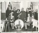 Winnipeg Free Press Archives
Winnipeg WWII Home Front
May 16, 1941
Drums For the Troops These bugles and drums will soon keep the beat in martial time for a unit of the Canadian army. They were presented to Military District No. 10 by the St. Boniface Kiwanis club at a luncheon, meeting, Thursday, at, the Nicolett  hotel. In the presentation pictured above are: Left to right, back row, Trafford Taylor, J. H. Mooradian, president of the club: Gladys Forrester, of the club's Thumbs Up revue; Lt.-Col. James Neish, who accepted the instruments presented by Mayor George MacLean, right. Front row, left to right, Dorothy Johnston and Ruth King, of the Thumbs Up revue.