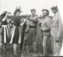 Winnipeg Free Press Archives
Winnipeg WWII Home Front
June 30, 1941
Beauty Pays Tribute to Soldiers of the King Mrs Ingram trys her hand at loading a trench mortar under the direction of Major R.H. Baxter commanding   Co. Infantry Training centre. R.G. Graham, officer Commanding Infantry Training Centre looks on.