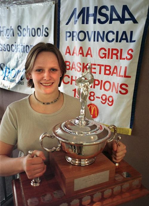 Sports - See Cariou Story - Marsha Murdock holds the trophy that she and her teammates of the Oak Park Raiders, hope to win in the AAAA Provinical High School Basketball Championship. - Heather HUdak photo March 16, 1999