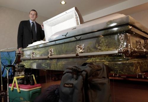 January 7, 1999--Brandon, MB--Todd Lumbard, president of Brockie Donovan funeral directors in Brandon, poses with one of the caskets in stock with artwork on it. Photo by Fred Greenslade