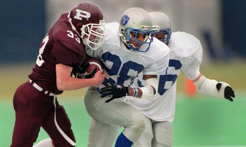 ken gigliotti \ winnipeg free press  Winnipeg High School football Final , winning Oak park Raiders running back Astaire Cummings carrys ball   being tackled by St. Paul's raider (no name for this number on roster) ckmstory , i think cummings was offensive player of the game\kg nov 10 2001