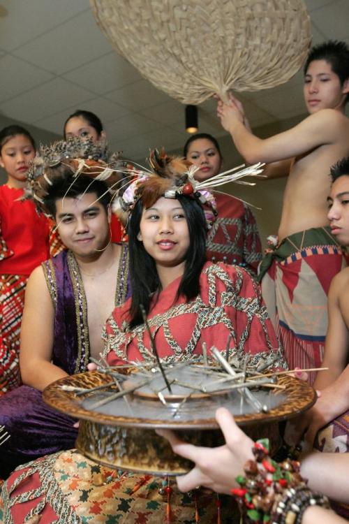 WINNIPEG: NOVEMBER 4, 2004. Jan Reyes, who plays the part of King Marikudo,and Queen Maniwangtiwang, played by Krystle Pagkalinawan, smile as they are given offerings at a dress rehearsal of "Maniwangtiwang", at the Philippine Canadian Centre of Manitoba on Thursday evening. The show will be performed at a gala dinner on Saturday evening, which will be the first annual fundraiser for the centre on Keewatin. Photo by Marianne Helm/Winnipeg Free Press