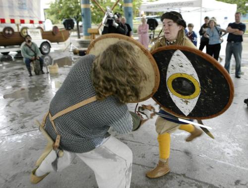 John Woods / Winnipeg Free Press / August 4 2006 - 060804 - Alison Mercer (aka Sjlave Swarta) (R) and James Welourne (aka Drengr Athalricsson) re-enact a viking battle during a Icelandic Festival press conference at the Forks  Friday, August 4/06.  The 117th Icelandic Festival will be in Gimli Aug. 4 - 7/06.