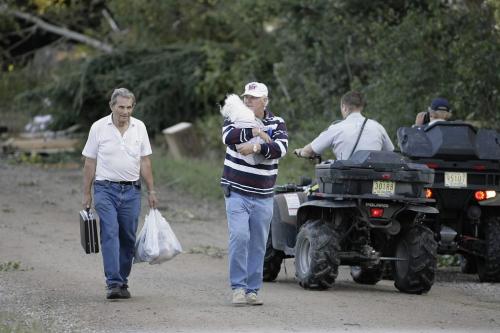 John Woods / Winnipeg Free Press / August 5 2006 - 060805 - Residents of  a campground at Gull Lake walk away after a tornado hit and killed one Sat. August 5/06.