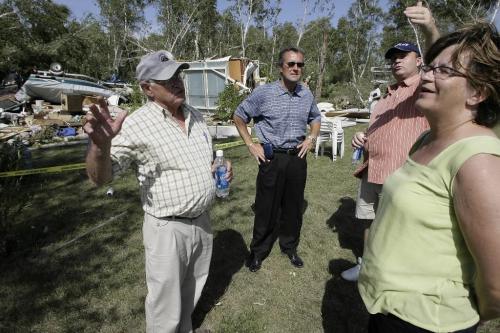 John Woods / Winnipeg Free Press / August 8 2006 - 060808 - George Harbottle (L), reeve of Alexander, and Steve Strang, reeve of St. Clements talk to Scott Smith, minister of intergovernmental affairs, and Rosann Wowchuck, deputy premiere, as they tour the devastated Gull Lake trailer park Tuesday, August 8/06, a couple of days after a tornado ripped through Gull Lake Saturday, August 5/06.