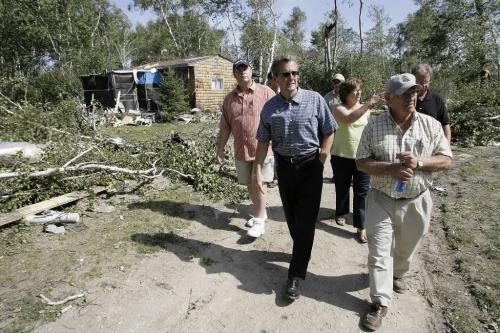 John Woods / Winnipeg Free Press / August 8 2006 - 060808 - George Harbottle (R foreground), reeve of Alexander, and Steve Strang (L background), reeve of St. Clements walk with Scott Smith, minister of intergovernmental affairs, and Rosann Wowchuck, deputy premiere, as they tour the devastated Gull Lake trailer park Tuesday, August 8/06, a couple of days after a tornado ripped through Gull Lake Saturday, August 5/06.