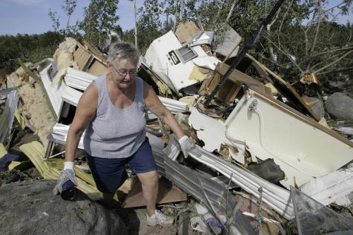 John Woods / Winnipeg Free Press / August 8 2006 - 060808 - Linda Godlein walks away from the remains of her trailer after finding a travel mug in the rubble Tuesday, August 8/06, a couple of days after a tornado ripped through Gull Lake Saturday, August 5/06.