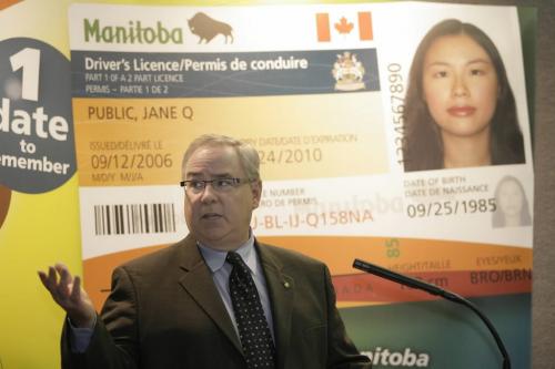 John Woods / Winnipeg Free Press / August 29 2006 - 060829 - John Douglas, vice president of Corporate Public Affairs for MPIC, announces to media at a press conference Manitoba's new drivers license Tuesday, Aug 29/06.  The new license has an increased number of security features.