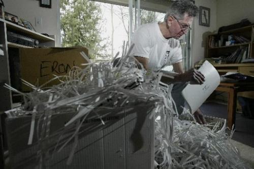 Jim Tindle does some shredding of his Eron files at his home in Vancouver, BC. April 1, 2005. Last week the former president of Eron Mortgage Corp. Brian Slobogian, was given a six-year prison term on Tuesday in a fraud case called the biggest in British Columbia history. Lyle Stafford/Winnipeg Free Press