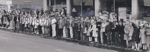 crowds along the entire route waved farewell to the last car. here children from Norquay School, whose history has closely resembled that of the street cars, line the curb on Main Street and wave as they get their last view of the City's street cars. september 20 1955 winnipeg free press