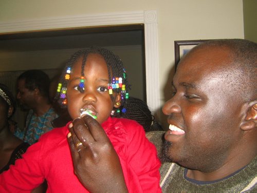Kenneth Otieno, his wife Dorcas, at their little girl Michelles second birthday party last month. - for gordon sinclair story winnipeg free press