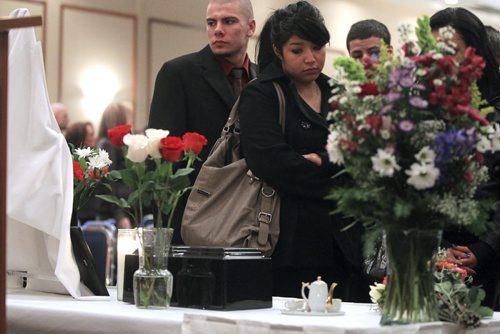 MIKE.DEAL@FREEPRESS.MB.CA 101204 - Saturday, December 04, 2010 - Farewell to Parents Mourners pay their respects to Marcel and Brenda Dubois's ashes after the memorial service at the Victoria Inn. See Geoff Kirbyson story. MIKE DEAL / WINNIPEG FREE PRESS