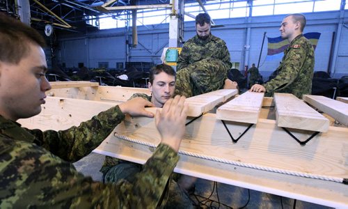 MIKE.DEAL@FREEPRESS.MB.CA 101204 - Saturday, December 04, 2010 - Members of the Arctic Response Company Group build a Komatiks (long sleighs) on Saturday as they prepare for exercise Northern Bison 2011 which will take place in February. The Komatiks will be a key component during the exercise where soldiers will be conducting a 300 km trek from Churchill, MB to Arviat, NU. MIKE DEAL / WINNIPEG FREE PRESS
