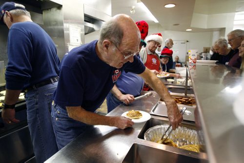 MIKE.DEAL@FREEPRESS.MB.CA 101204 - Saturday, December 04, 2010 - Don MacAulay (foreground) and other retired firefighters dish out a pancake breakfast Saturday morning at the Salvation Army's Weetamah Centre.
See Erin Madden volunteer story. MIKE DEAL / WINNIPEG FREE PRESS