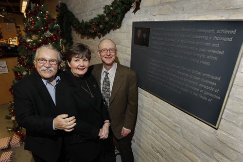 Ruth Bonneville Winnipeg Free Press Dec 09 , 2010 Local - Philanthropist and businessman John Buhler with his wife Bonnie and Free Press writer Morley Walker next to new plaque recently hung in the Buhler Commons of Red River River Library.  See Morley's column.
