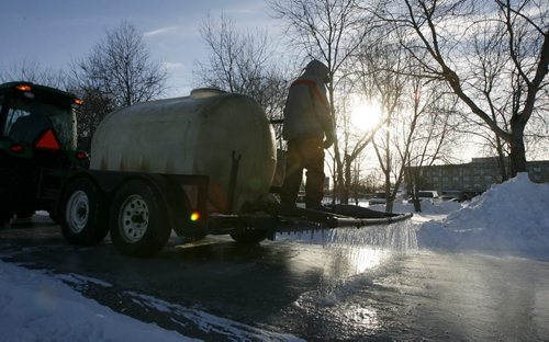 MIKE.DEAL@FREEPRESS.MB.CA 101210 - Friday, December 10, 2010 - A Forks grounds crew sprays water onto the skating path in preparations for the weekend. Both the rink in front of the Scocia Bank Stage and under the canopy are well on their way to being perfect for the weekend. MIKE DEAL / WINNIPEG FREE PRESS