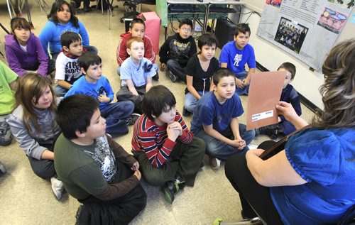 MIKE.DEAL@FREEPRESS.MB.CA 101214 - Tuesday, December 14, 2010 - Children in the grade four Ojibwe language class at Strathcona School. Teacher Elaine Mayham shows drawings on animal tracks and talks about the animals with the students in Ojibwe. MIKE DEAL / WINNIPEG FREE PRESS