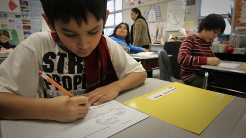 MIKE.DEAL@FREEPRESS.MB.CA 101214 - Tuesday, December 14, 2010 - Children in the grade four Ojibwe language class at Strathcona School. Ricky Henderson, 9, draws a mouse on a worksheet that will include its tracks and objibwe name waabigozhiish. MIKE DEAL / WINNIPEG FREE PRESS