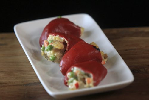 MIKE.DEAL@FREEPRESS.MB.CA 101215 - Wednesday, December 15, 2010 - Carolina Konrad and chef Adam Donelly in their Tapas restaurant Segovia on Stradbrook Avenue. In the photo is the Russian Salad Stuffed Piquillo Peppers. See Wendy Burke story. MIKE DEAL / WINNIPEG FREE PRESS