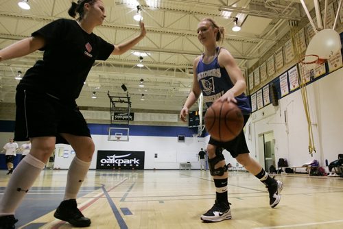 December 17, 2010 - 101217  - Brittany Rosenfelt (R), who plays on the women's varsity team for the Oak Park Raiders and has torn her ACL twice, goes for the net against a team-mate during practice on Friday, December 17, 2010. Rosenfelt had her first ACL injury repaired but has to  wait until March to have it repaired again. John Woods / Winnipeg Free Press