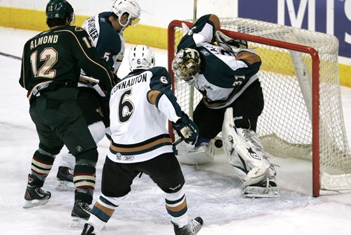 December 17, 2010 - 101217  - Houston Aeros Cody Almond (12) moves in for the rebound as a shot off the glass bounces off the back of Manitoba Moose Eddie Lack (31) for a goal in the first period of their AHL game in Winnipeg on Friday, December 17, 2010.  John Woods / Winnipeg Free Press