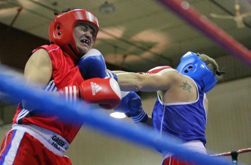 Brandon Sun Bert Blackbird and Riley Parker lock horns inside the ring during the Merry Christmas and Season's Beatings amateur boxing event held in the Manitoba Room on Sunday. (Bruce Bumstead/Brandon Sun)