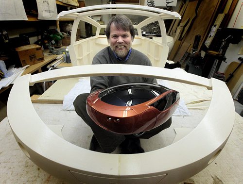 PHIL.HOSSACK@FREEPRESS.MB.CA 101220-Winnipeg Free Press Holding a 1/4 scale replica, Jim Kor sits in plastic body panels for his electric car "Urbee". Panels are "printed" with a 3D printer out of plastic for the vehicle....Murray's tale.