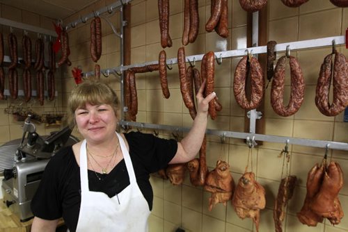 MIKE.DEAL@FREEPRESS.MB.CA 101222 - Wednesday, December 22, 2010 - European Meats front counter employee, Nancy Zanella with some of the Hungarian sausage for sale. MIKE DEAL / WINNIPEG FREE PRESS