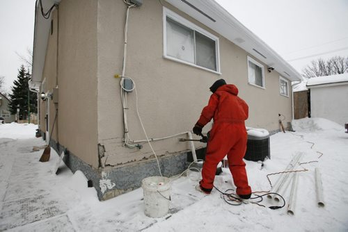 December 22, 2010 - 101222  -    A worker drills a whole in the wall of 845 Alfred as part of the installation of a new furnace. The residents of this home at 845 Alfred were rushd to hospital early this morning, Wednesday, December 22, 2010, suffering from Carbon monoxide poisoning.  John Woods / Winnipeg Free Press