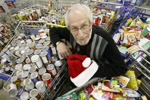 December 22, 2010 - 101222  -    Kai Madsen of the Winnipeg Cheer Board poses for a photograph, Wednesday, December 22, 2010, with some of the goods that are distributed each year in their hampers.  John Woods / Winnipeg Free Press  *he would not wear hat for Spirit of Christmas" feature.