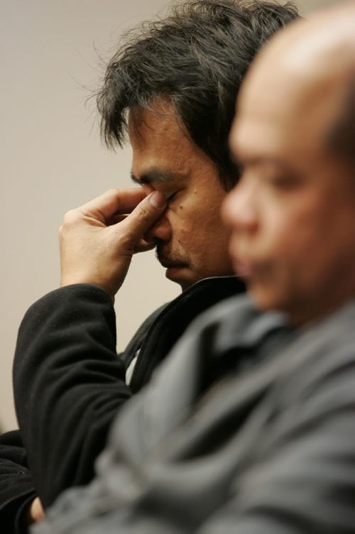 December 23, 2010 - 101223  -   Arnistito Gaviola (R) listens as Antonio Laroya wipes tears as his daughter speaks in his favour via speaker phone  at a press conference on Thursday, December 23, 2010 at the Broadway Disciples United Church in support of the Three Amigos, three migrante workers who face deportation. John Woods / Winnipeg Free Press